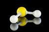 A plastic model of a molecule of hydrogen sulfide, with a yellow sulfur atom and two white hydrogen atoms