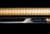 A ruler against a glass tube with smoke forming inside