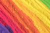 Different coloured powdered pigments forming a rainbow pattern