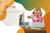 Photo of a young girl putting a plastic bottle into a household bin