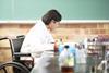 A photo of a student in a wheelchair during a practical science lesson