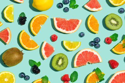 A photographic illustration of different fruits, whole and sliced, on a turquoise background