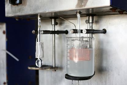 Electrolysis of copper sulfate solution in a laboratory setting, with visible copper