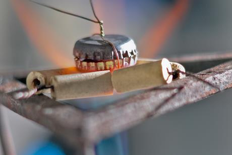 Two bottle tops in a bunsen burner flame