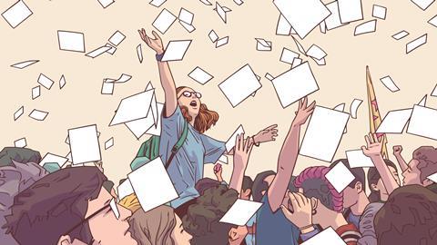 Students catching papers from the sky